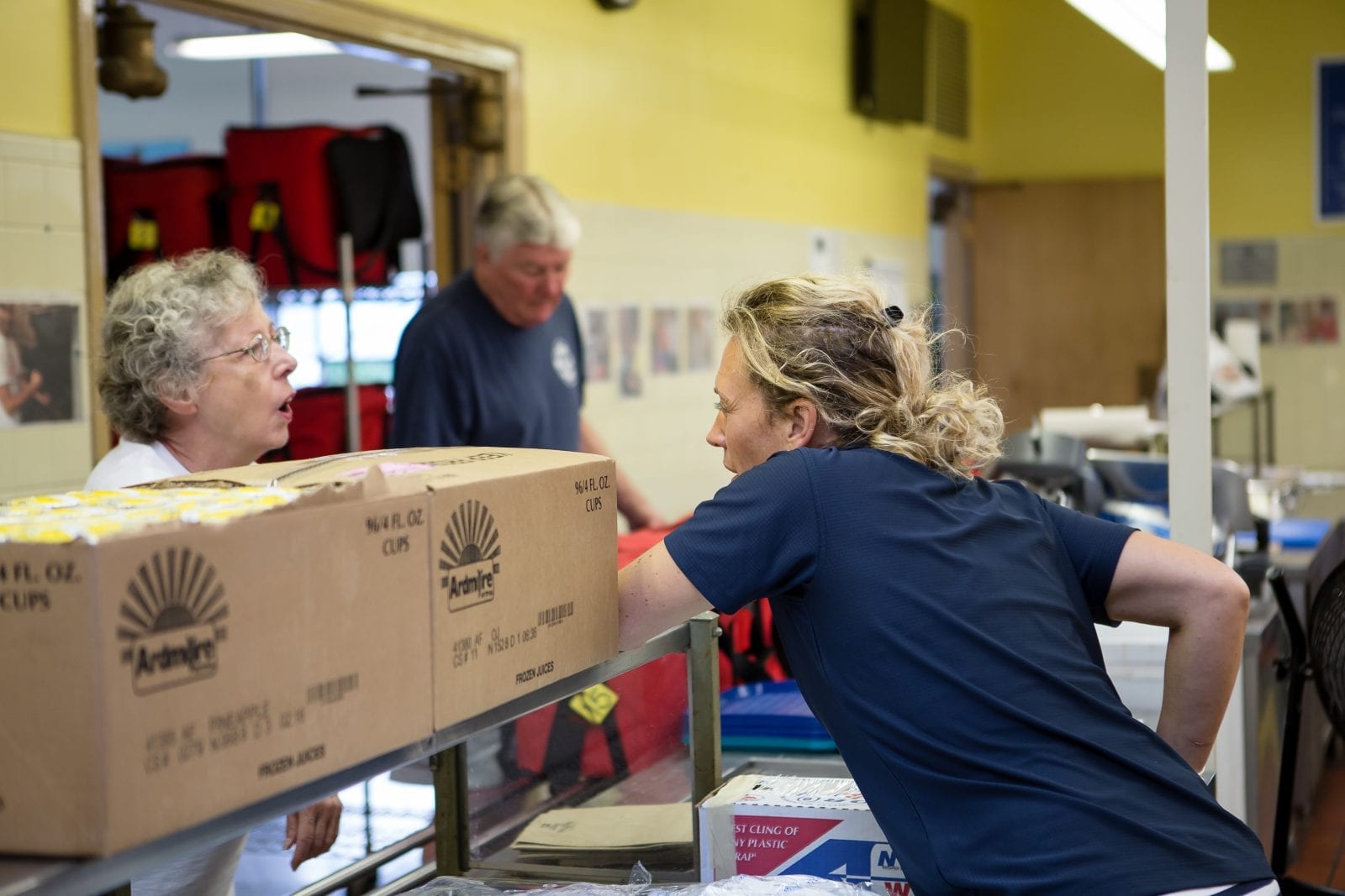 Volunteer distributing food for delivery at KenTon Meals on Wheels Kitchen